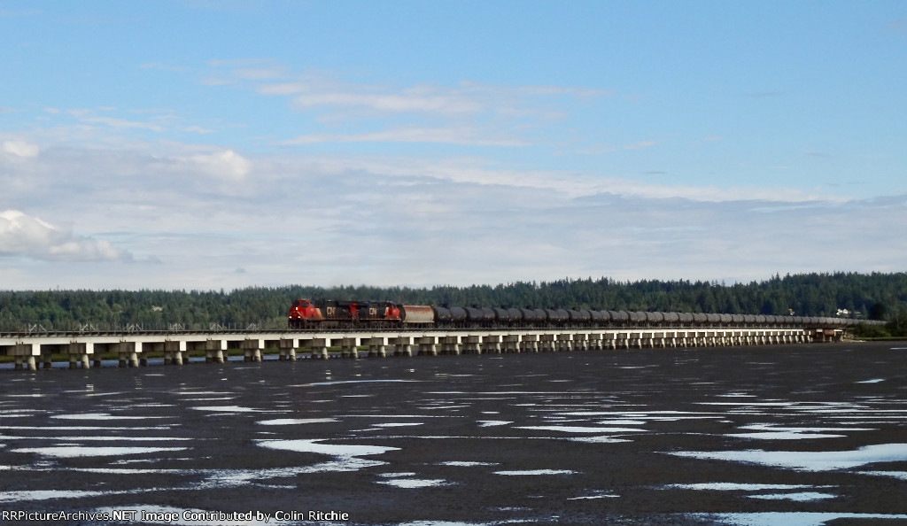 CN 2996/2804 leading a N/B unit tank train across Mud Bay crossing.